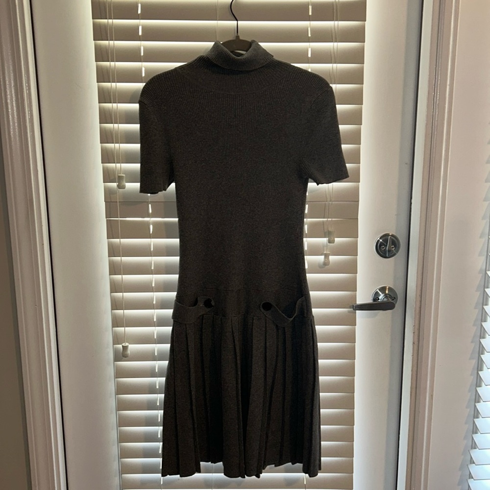Grey pleated sweater dress by Moda International.